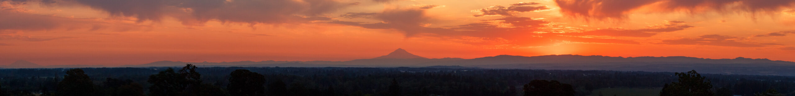 A panorama taken from Salem, Oregon featuring Mt. Adams (far left) and Mt. Hood (center).